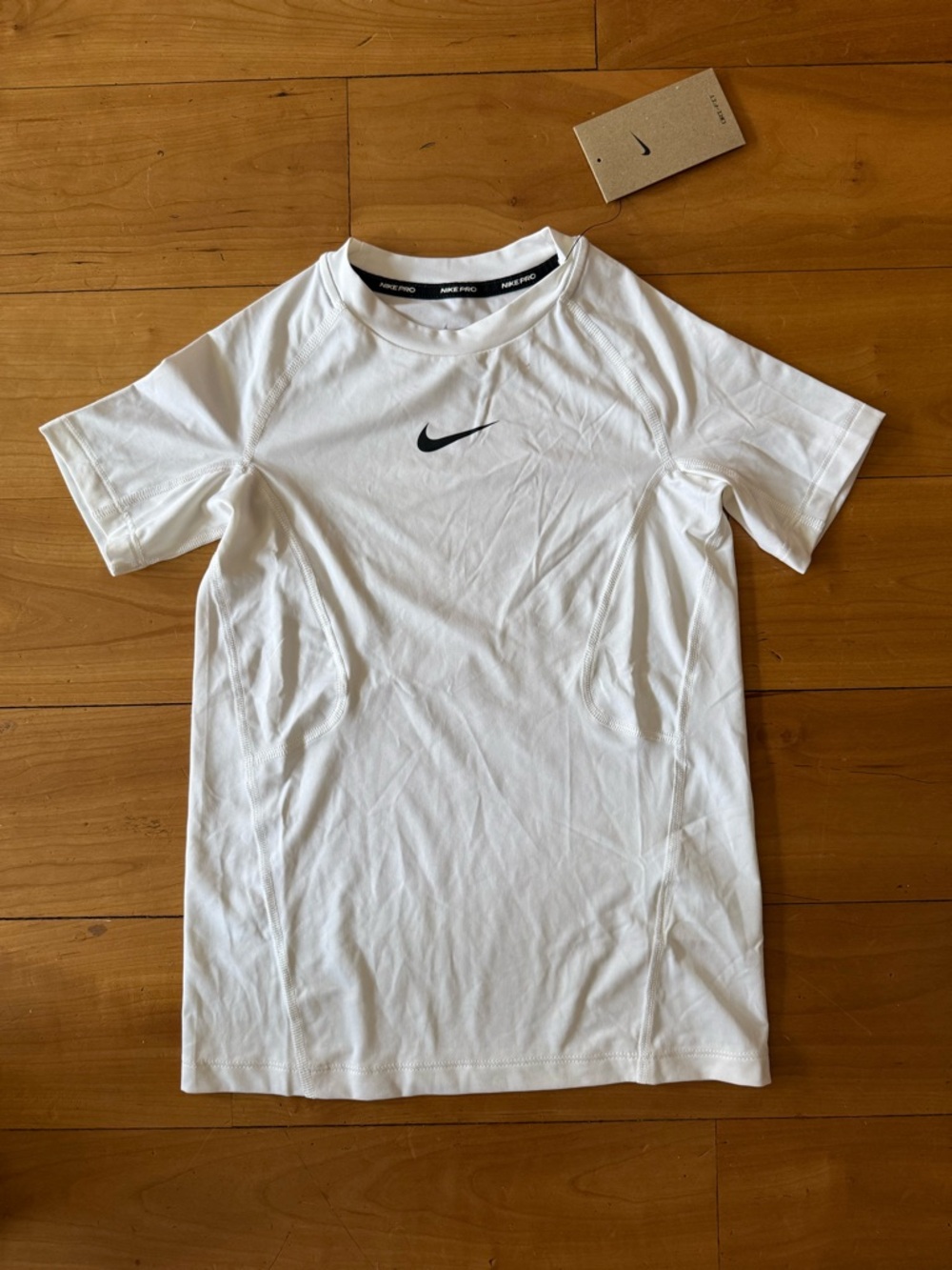 Nike White Short Sleeve Athletic Tee with Black Swoosh